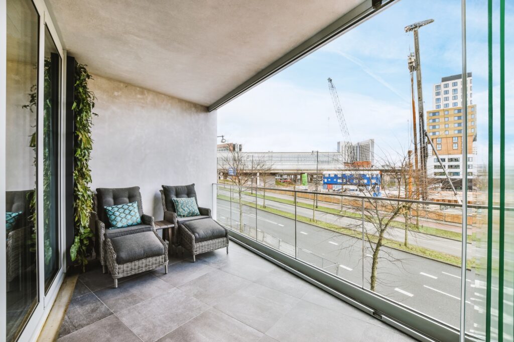 Spacious glazed balcony with comfortable armchairs